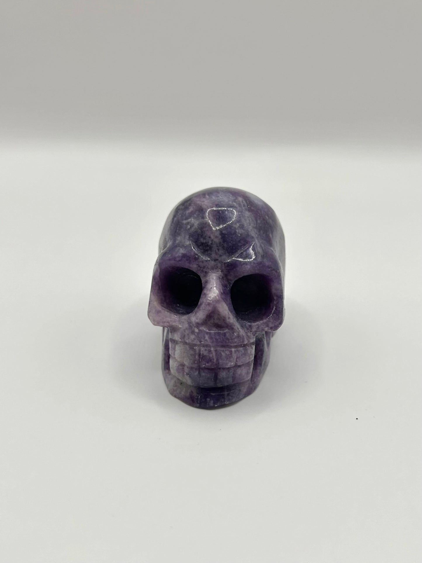 Lepidolite skull carving