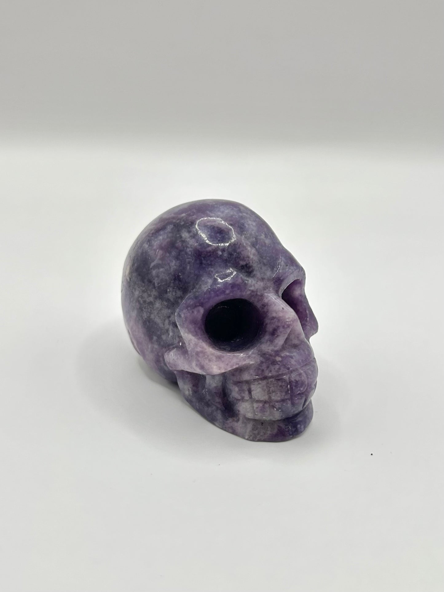 Lepidolite skull carving