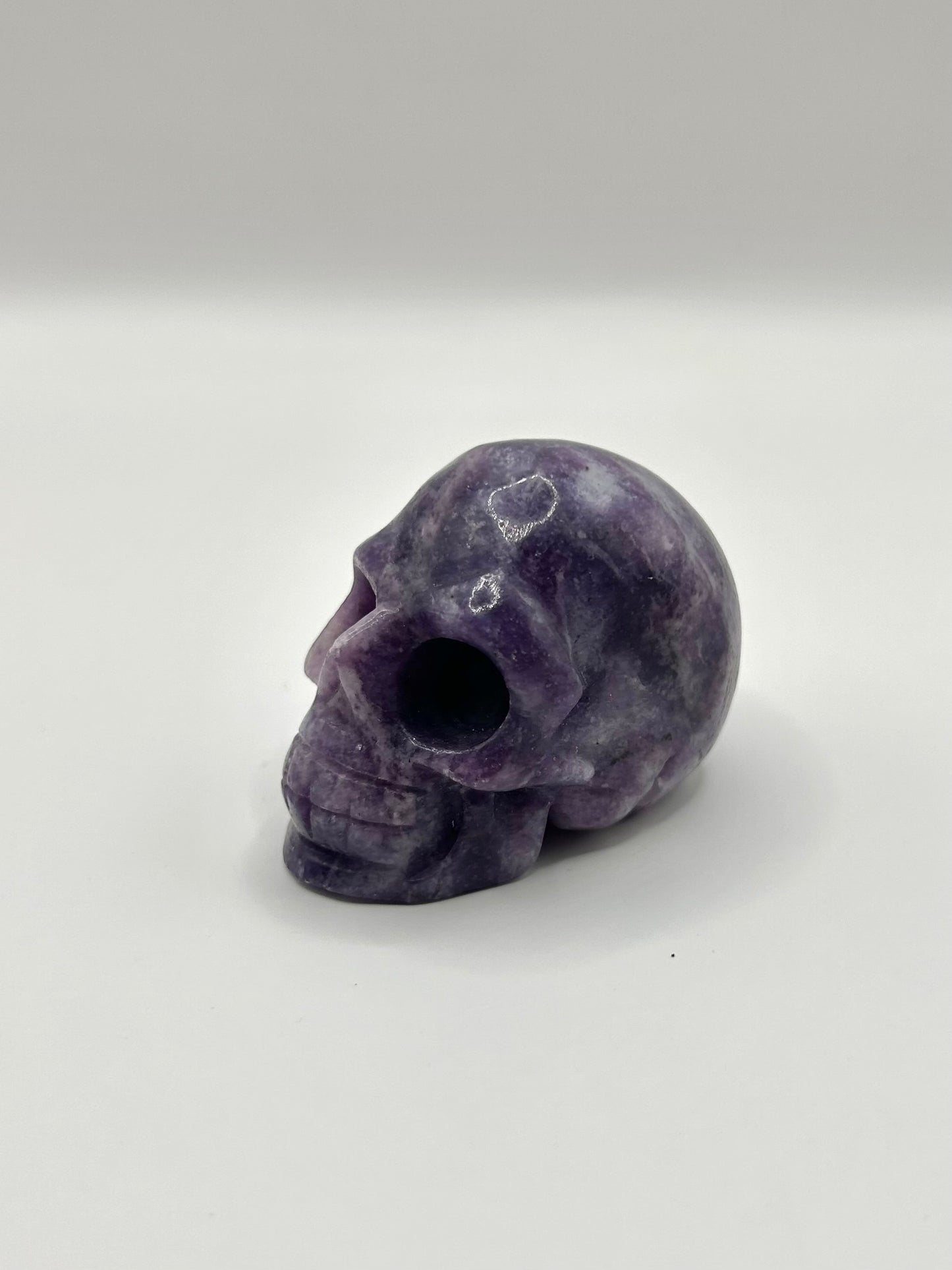 Lepidolite skull carving